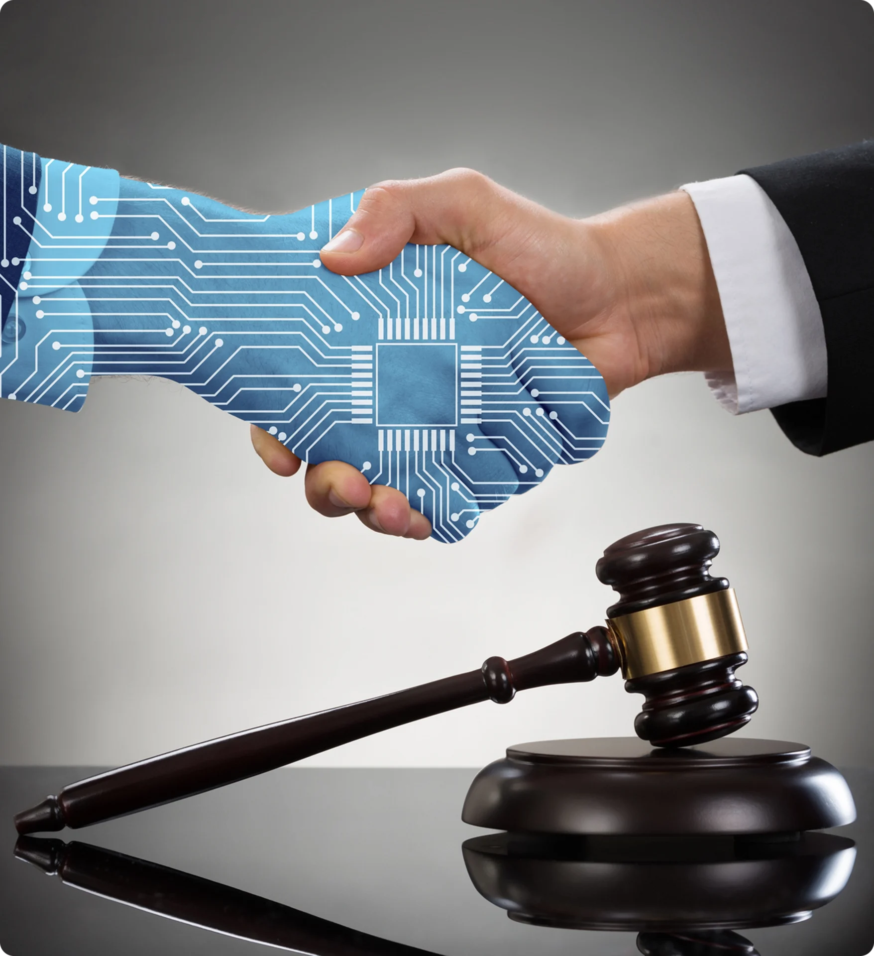 Digital handshake with gavel, symbolizing technology law.